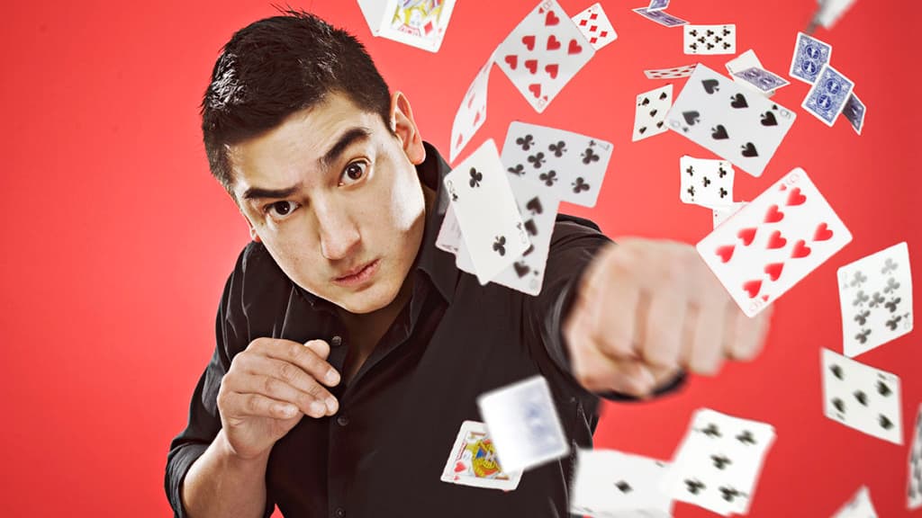 Javier Jarquin, the Card Ninja, punching a deck of cards in the air